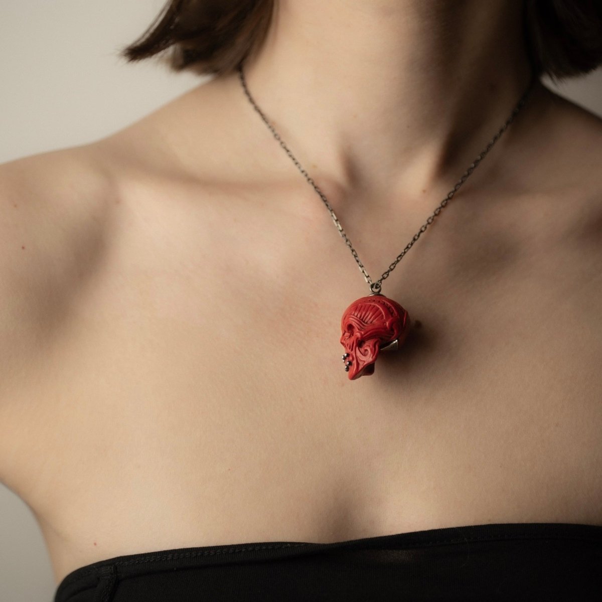 Ornate Skull pendant, red variant, on a female model