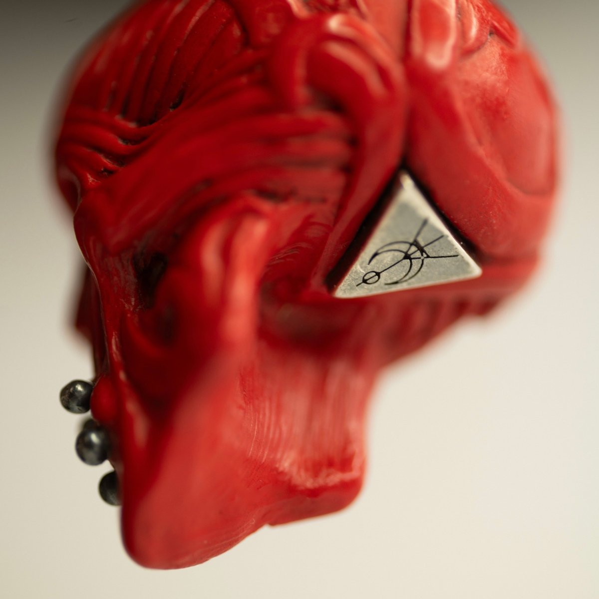 Ornate Skull pendant - close up on the sterling silver brand logo detail, underneath the skull pendant