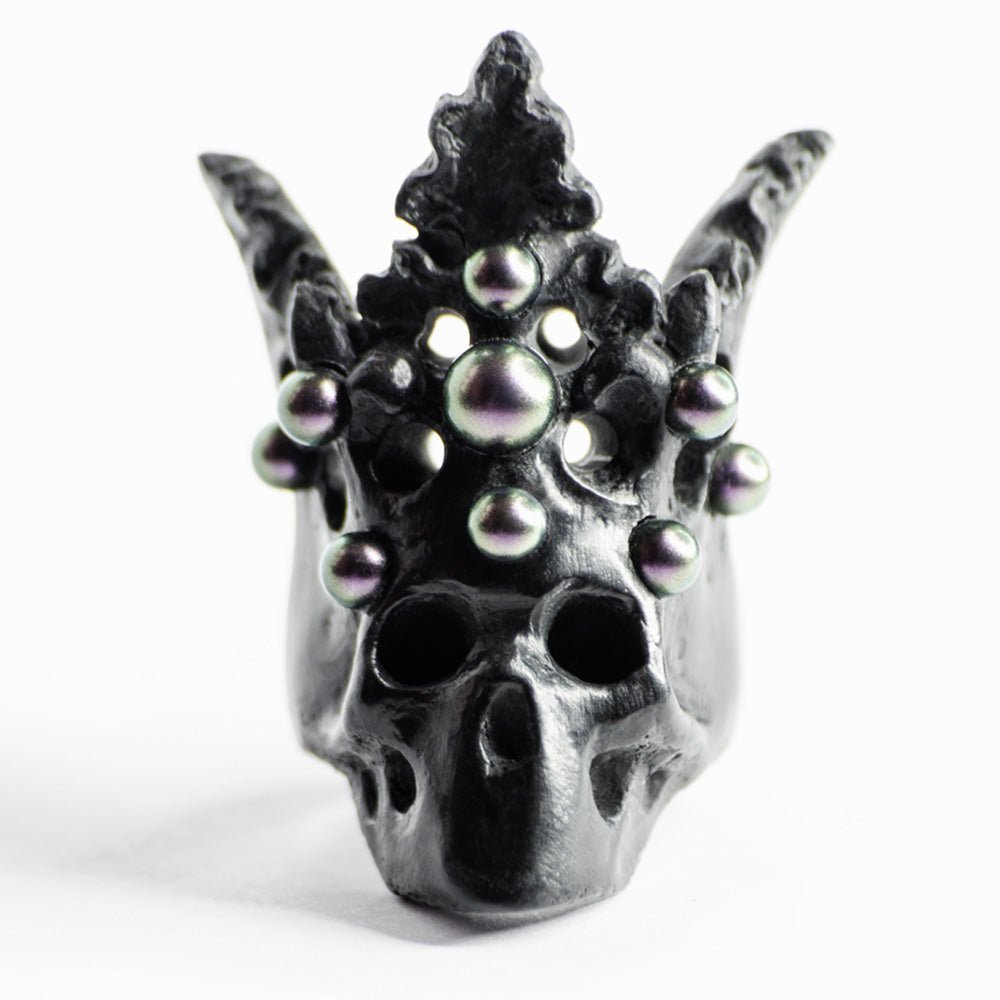 Pearl Crown Skull ring black variant — black marble skull with fleur-de-lys pearl crown on white surface | Macabre Gadgets