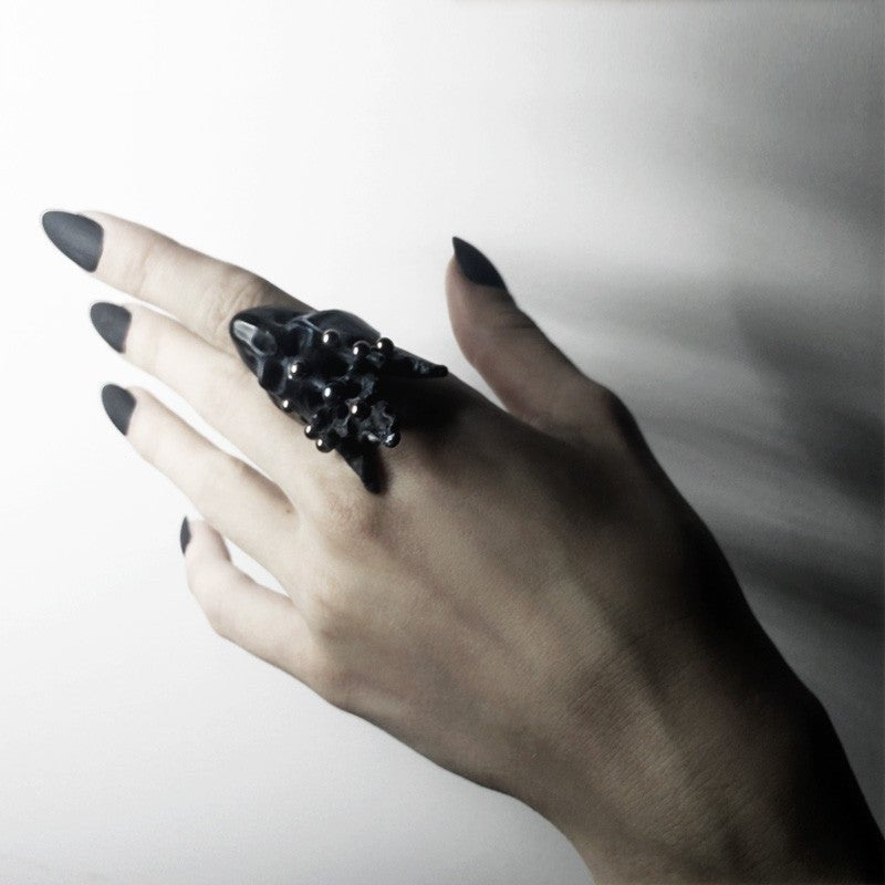 Female model wearing Pearl Crown Skull ring — white marble skull ring with pearl crown on hand | Macabre Gadgets
