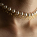 Pearl Net choker on a model's neck, focusing on the chain and how it's secured between pearls