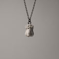 Phallus pendant - white variant - front view against light grey background