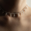 Sacred Pearls necklace on a model's neck, close-up