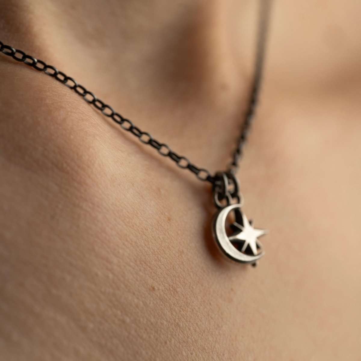 Selene Moon pendant with Asteria Silver Star pendant on a female's model neck