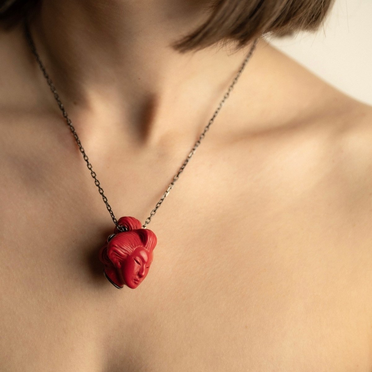 She pendant, red variant, on female model