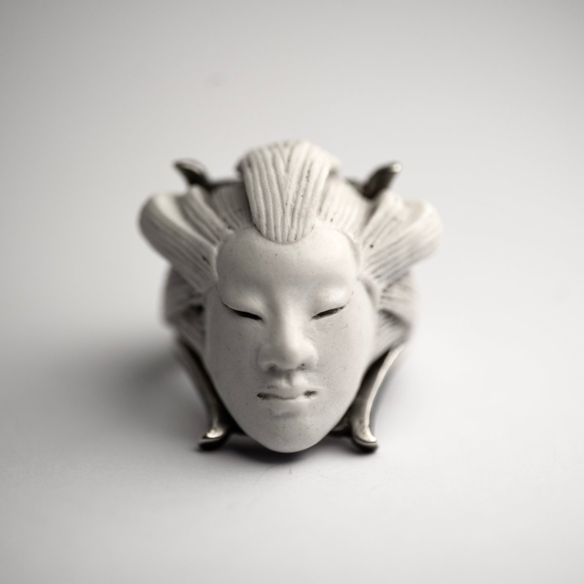 She ring - white variant, front view - white polished head relief on a white background creating a striking effect