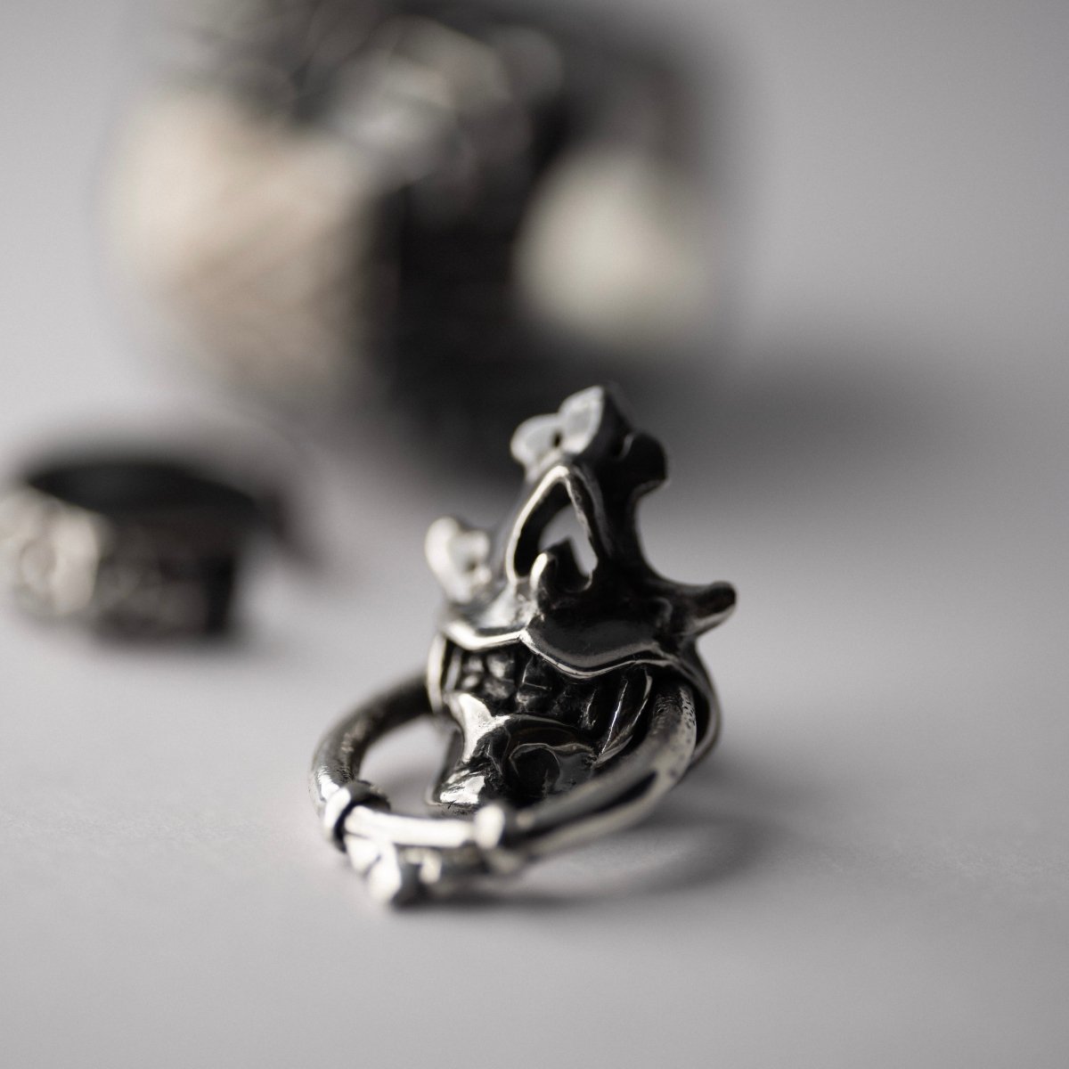 Silver Mask earring — styled with other Macabre Gadgets jewelry, DREAMS collection editorial