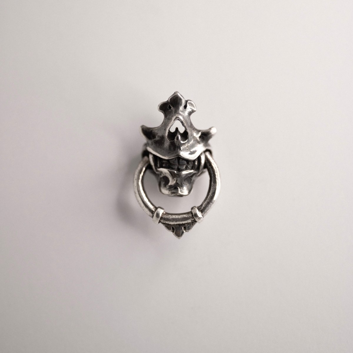 Silver Mask earring — sterling silver variant — front view against white background, showing full sculptural skull mask form