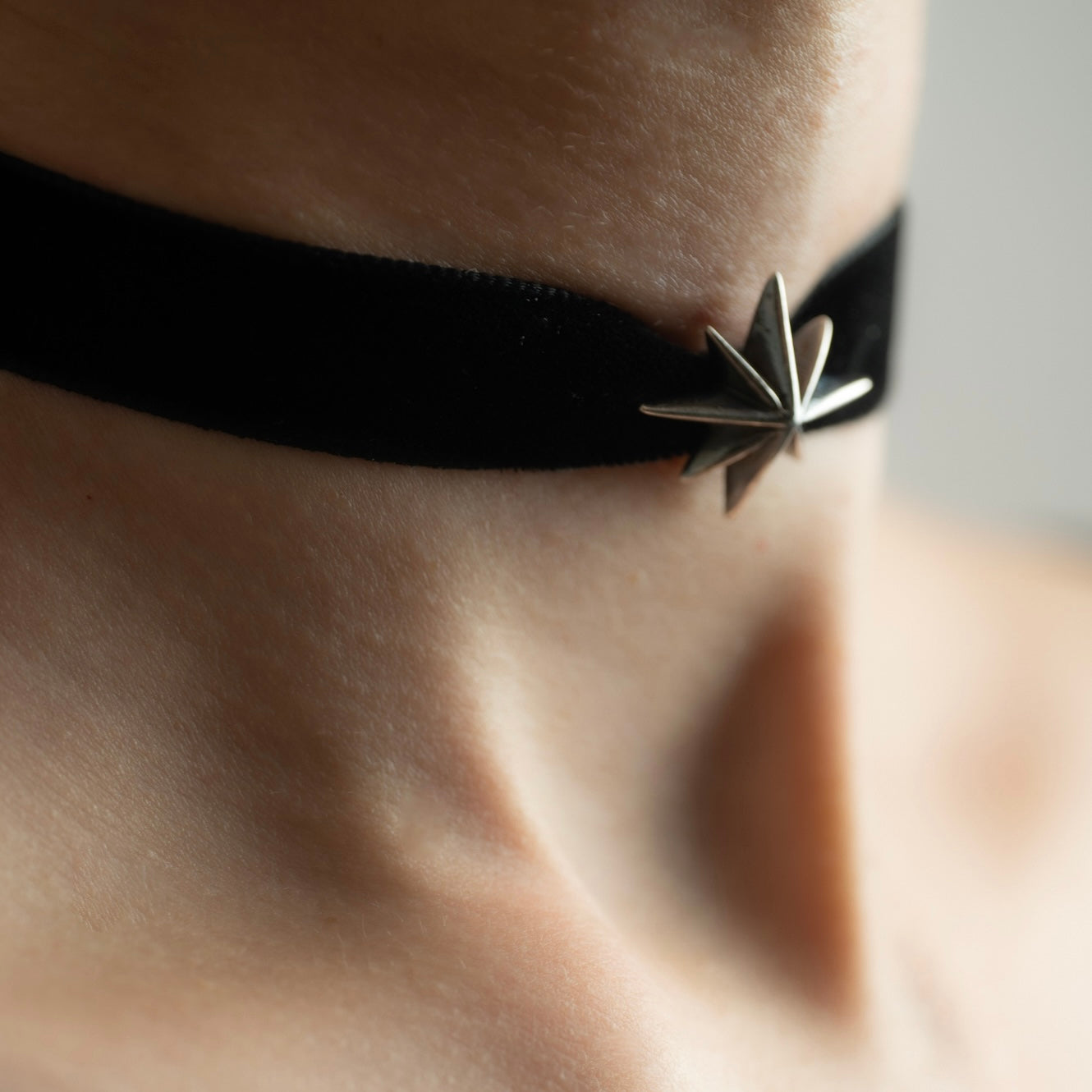 Silver Star Choker on model — side view, sterling silver star choker sitting high on the neck