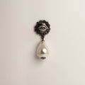 Sirius Pearl Drop earring with sterling silver eye design and pearl drop on neutral background, gothic mystical jewelry