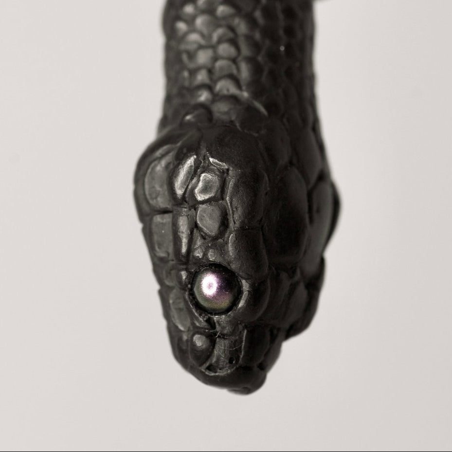 Snake Head pendant black variant - snake’s head men’s jewelry - closeup on pearl eye