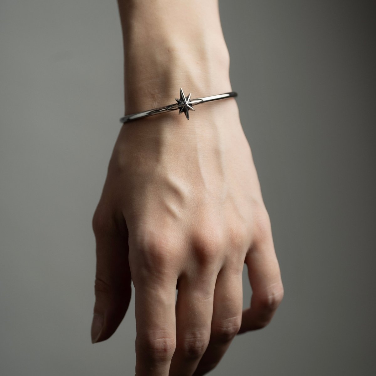 Star cuff bracelet on a female model's hand, clearly shows fit and dimensions