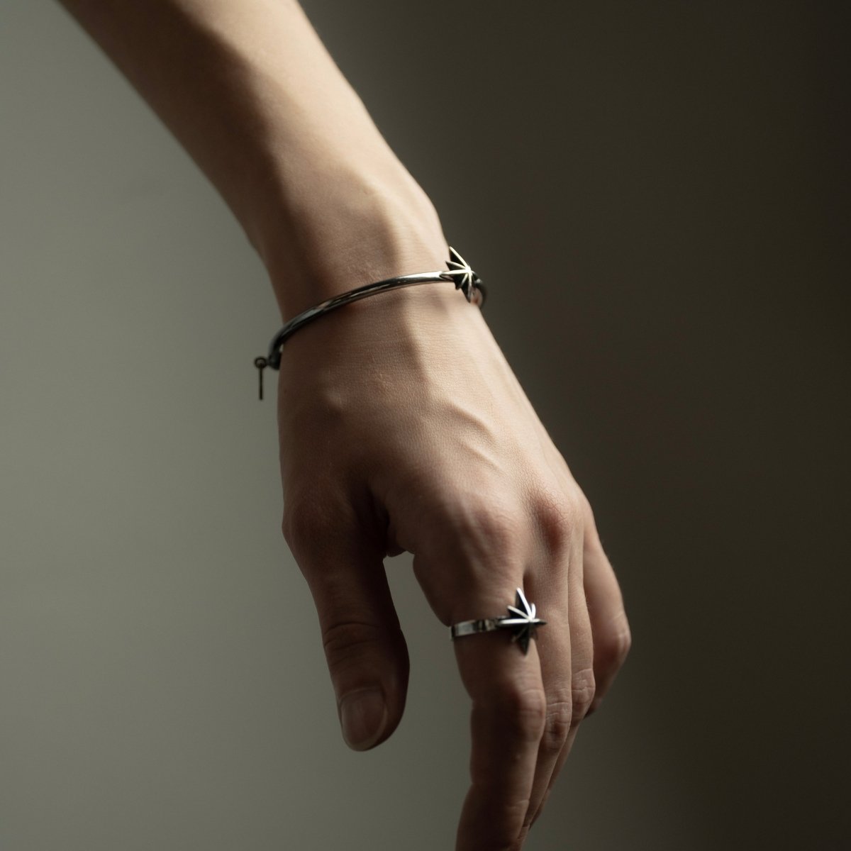 Star cuff bracelet and Star ring on the female model's hand