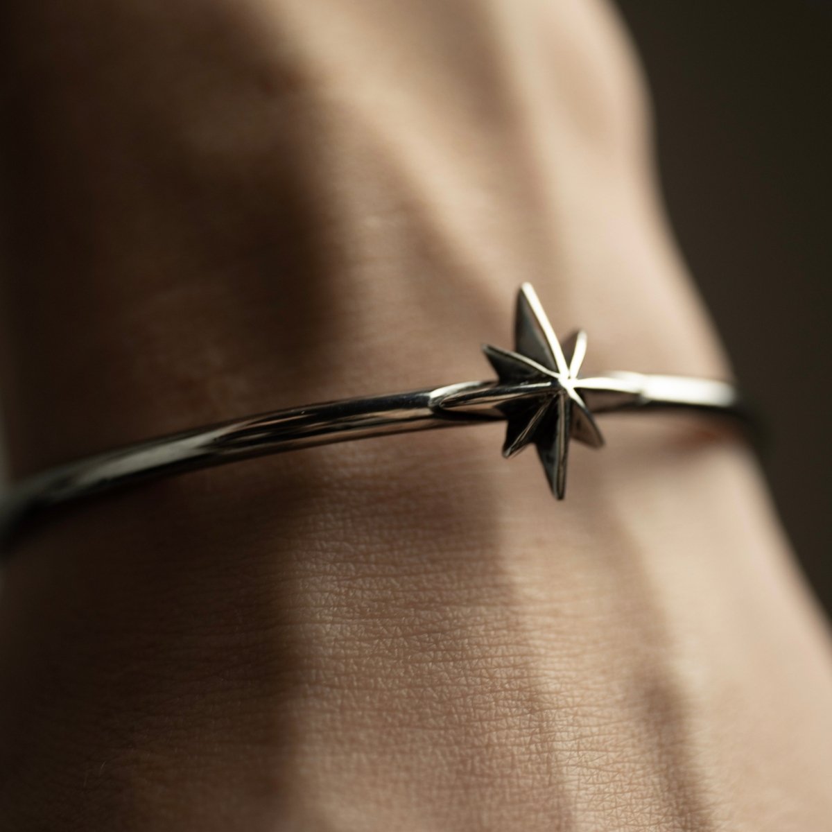 Star cuff bracelet on a wrist, close up on a star detail