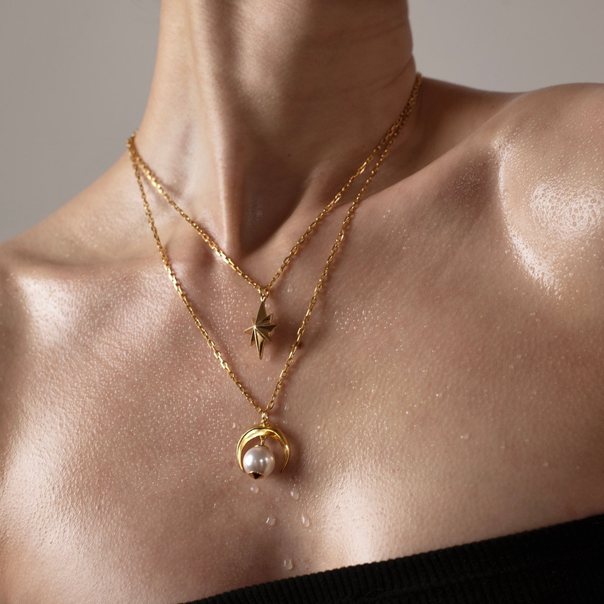 Gold star pendant and Crescent Moon pendant on female model — celestial necklaces by Macabre Gadgets