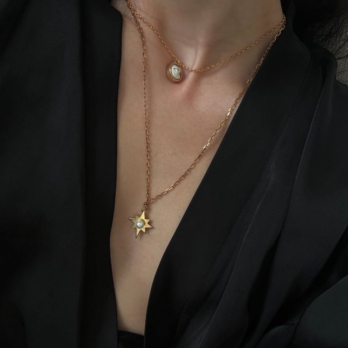 Star pendant on model with black neckline — styled with Eye pendant by Macabre Gadgets