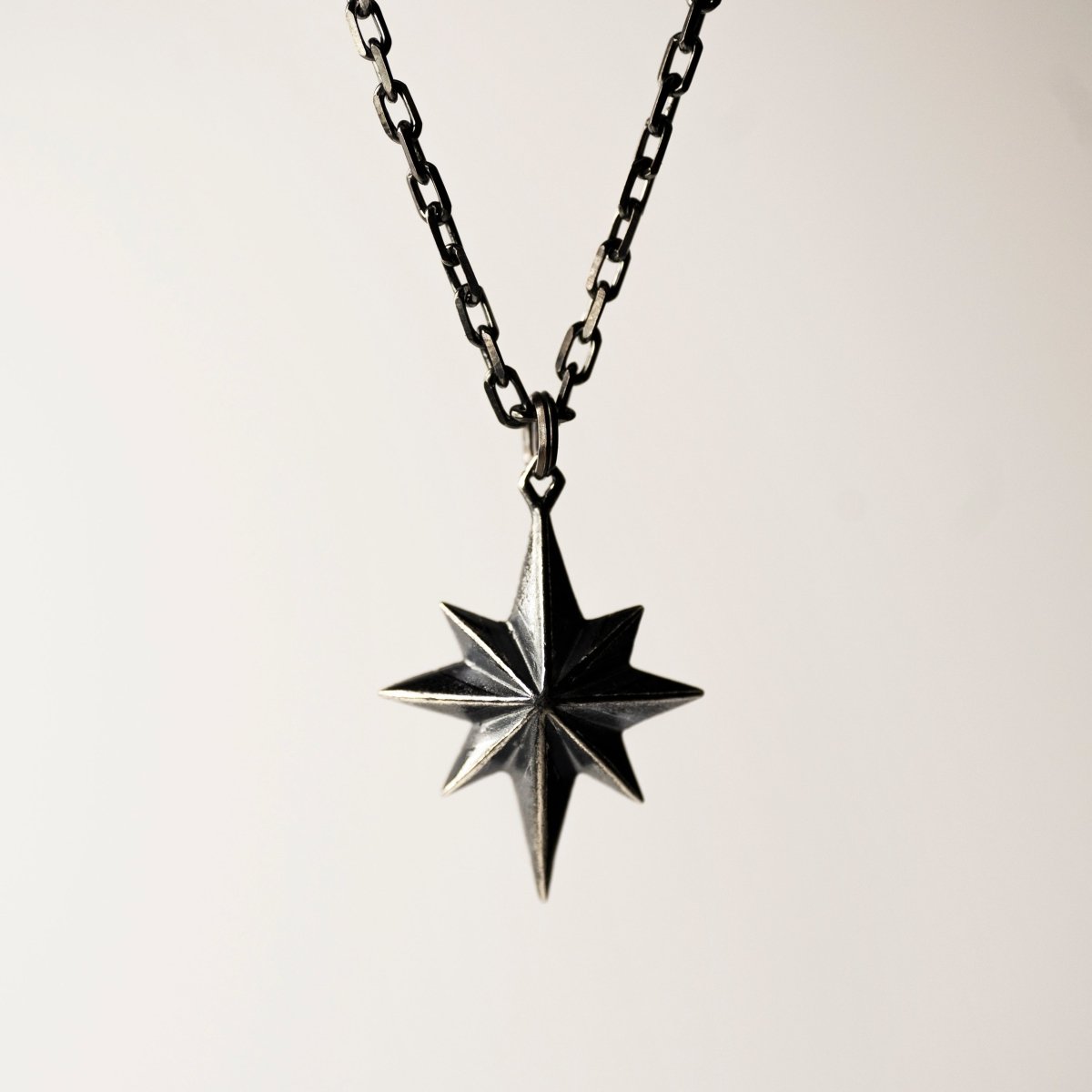 Sterling silver star pendant — front view, geometric 8-point star with hidden pearl on 50cm chain | Macabre Gadgets