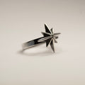 Star ring - placed on a white surface, semi side view, clear product picture
