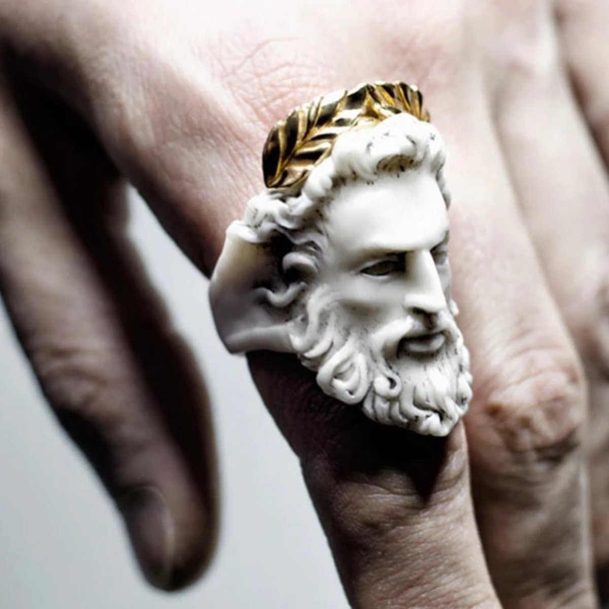 Zeus ring on a male hand, on index finger 