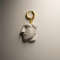 Achilles earring sculpture-like design featuring marble fragment of man's face on gold-plated huggie clasp, classical mythology jewelry