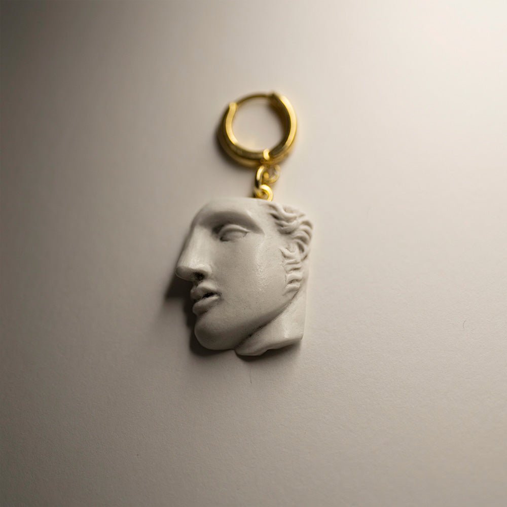 Achilles earring sculpture-like design featuring marble fragment of man's face on gold-plated huggie clasp, classical mythology jewelry