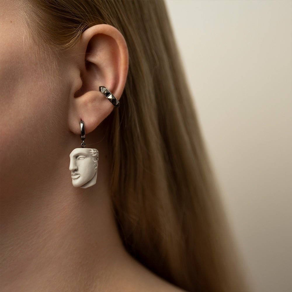 Female model with long hair wearing Achilles earring, Greek mythology marble sculpture jewelry lifestyle photography