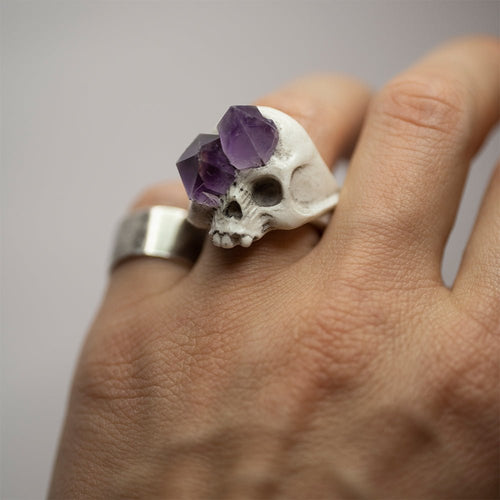 Amethyst Crystal Skull Ring on a male hand styled with a silver bend ring