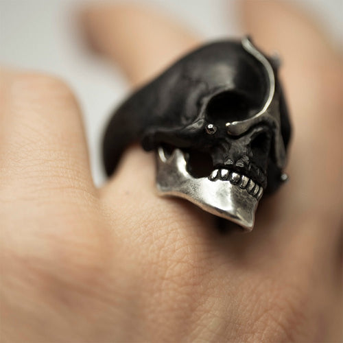 Ancient skull ring - black - silver variant, on a model's hand, close up