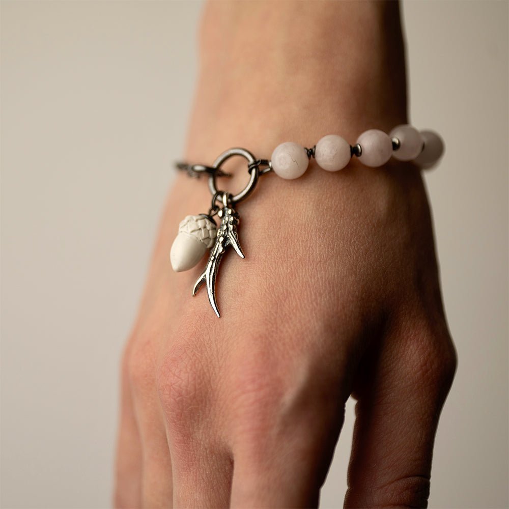 Silver Horn bracelet on a wrist - close up of charms details