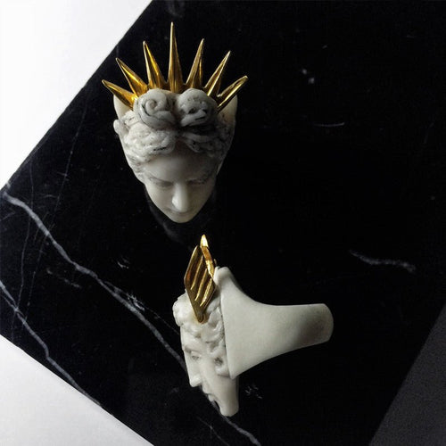 Apollo ring and Hermes ring on black marble surface - boho style mythology inspired jewelry lifestyle shot