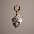 Ariadne earring close-up of marble sculpted woman's face on gold-plated sterling silver huggie clasp, Greek mythology princess jewelry
