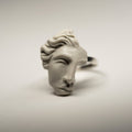 Ariadne ring - close-up of a sculptured face detail, its classical features and marble texture