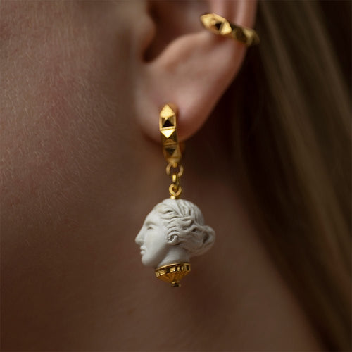 Artemis earring gold-plated on model's ear close-up, Greek mythology goddess jewelry lifestyle shot