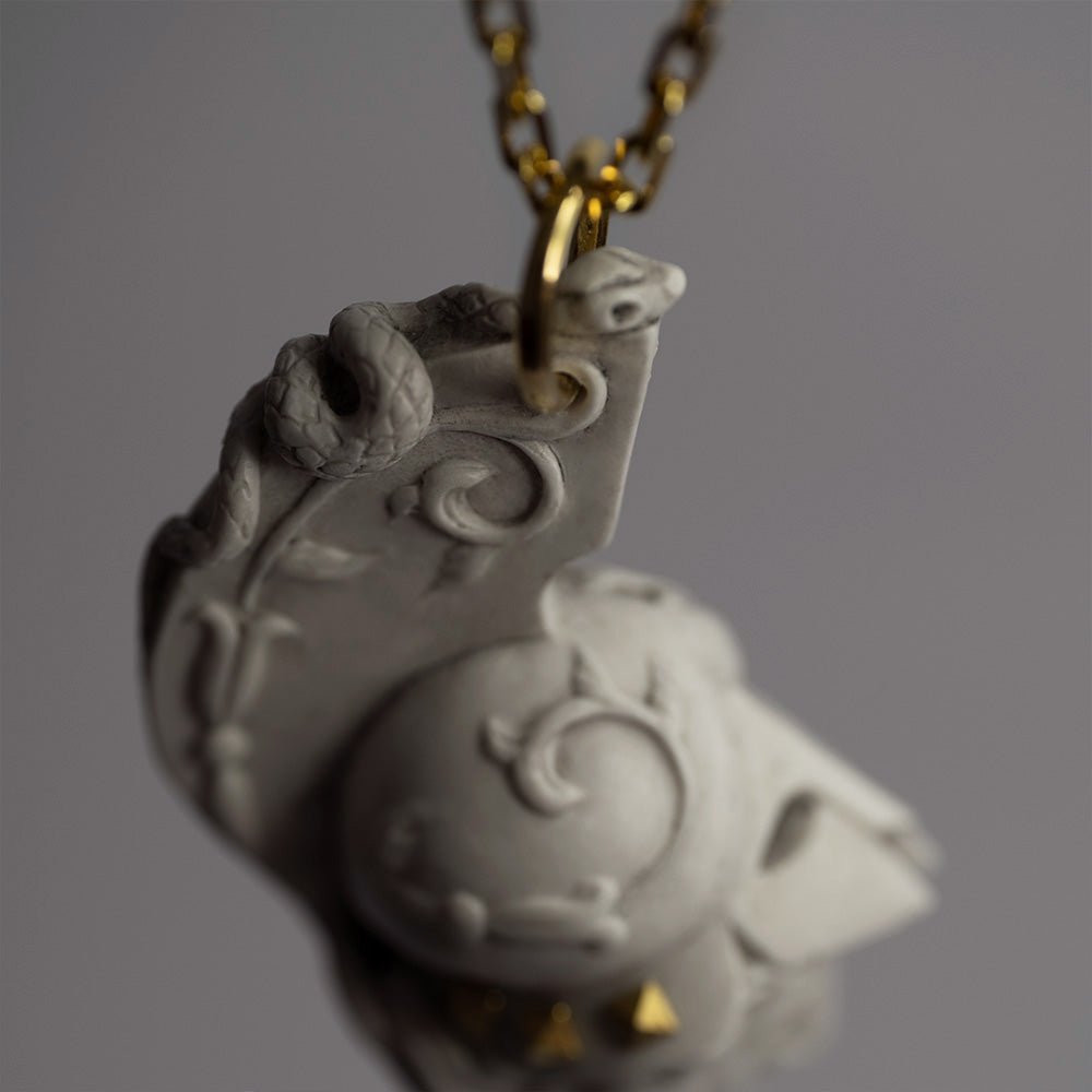 Athena pendant - close up on a snake, one of the goddess symbols, decorating a helmet crest 