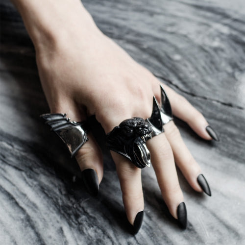 Bevor ring shown worn on a woman's hand with long black nails along with other rings by Macabre Gadgets