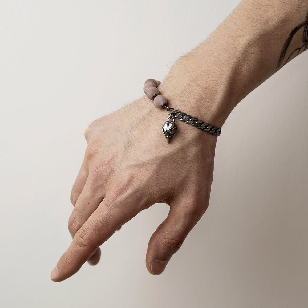 Bird Skull Bracelet on a male model's hand - charm, chain and beads are visible