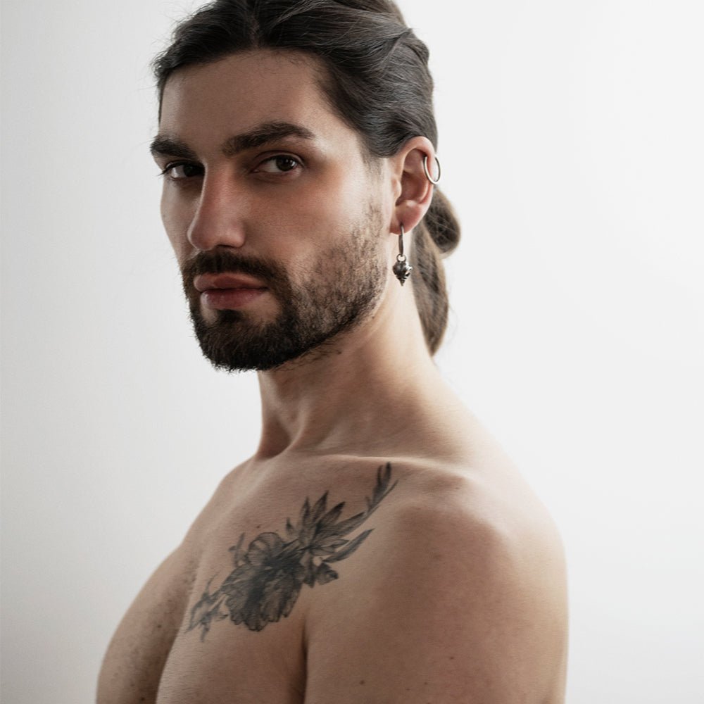 Male model wearing  Bird Skull earring - gothic sterling silver hoop earring
