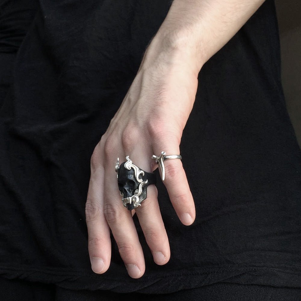 Black Mayla Skull ring on a man's hand on a black background