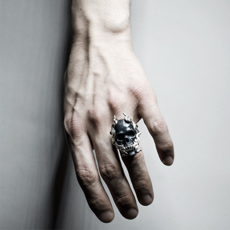 Black Mayla Skull ring on a man's hand, contrasting light and monochrome palette complementing ring's overall macabre appearance