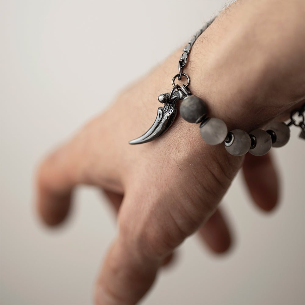 Claw Bracelet on a man's wrist, focus on a claw charm detail