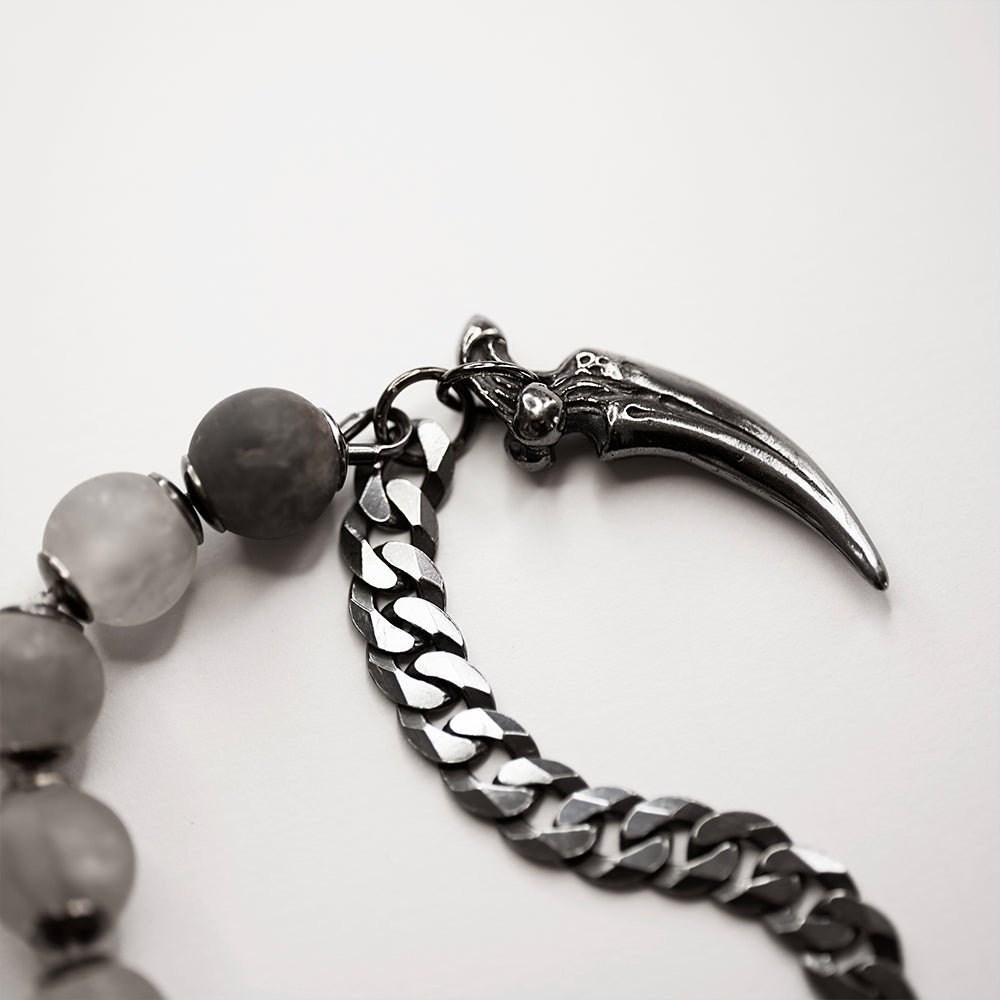 Claw Bracelet on a white surface - close up of claw charm detail, quartz beads and flat curb chain
