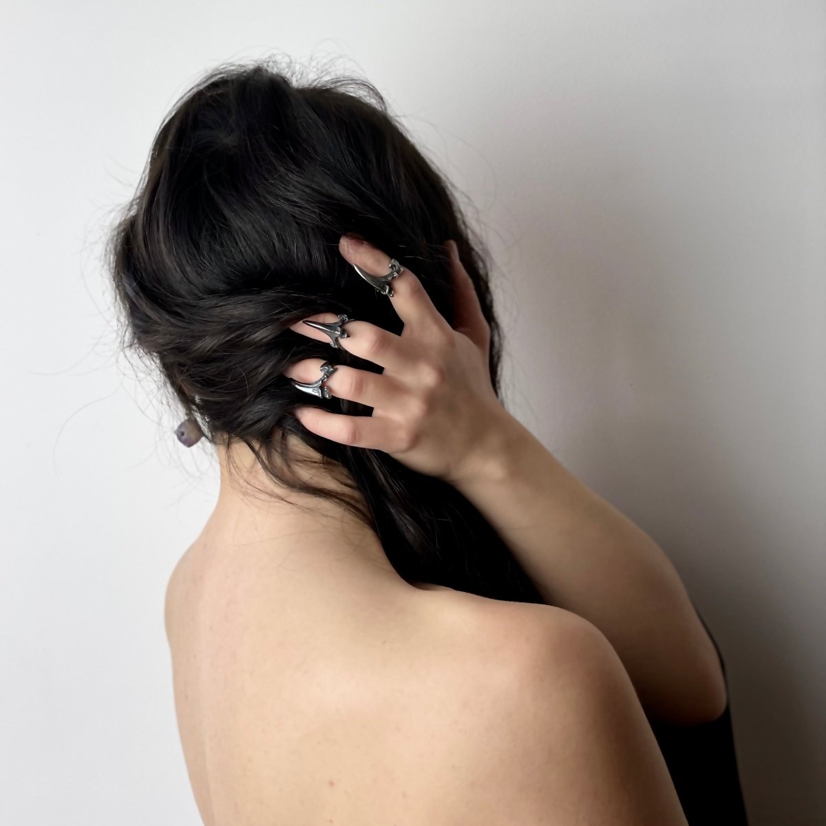 Claw phalanx ring - three of them on a female model with long wavy black hair