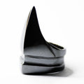 Semi-side view o the sleek minimalist silver ring in a shape that resembles a claw