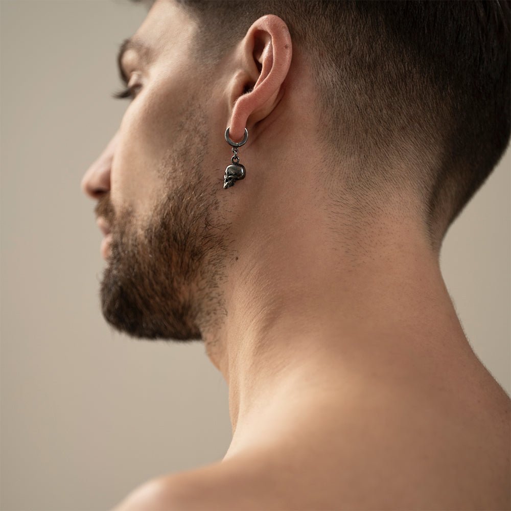 Male model wearing Silver Skull earring - to demonstrate this gothic skull earring fit and dimensions