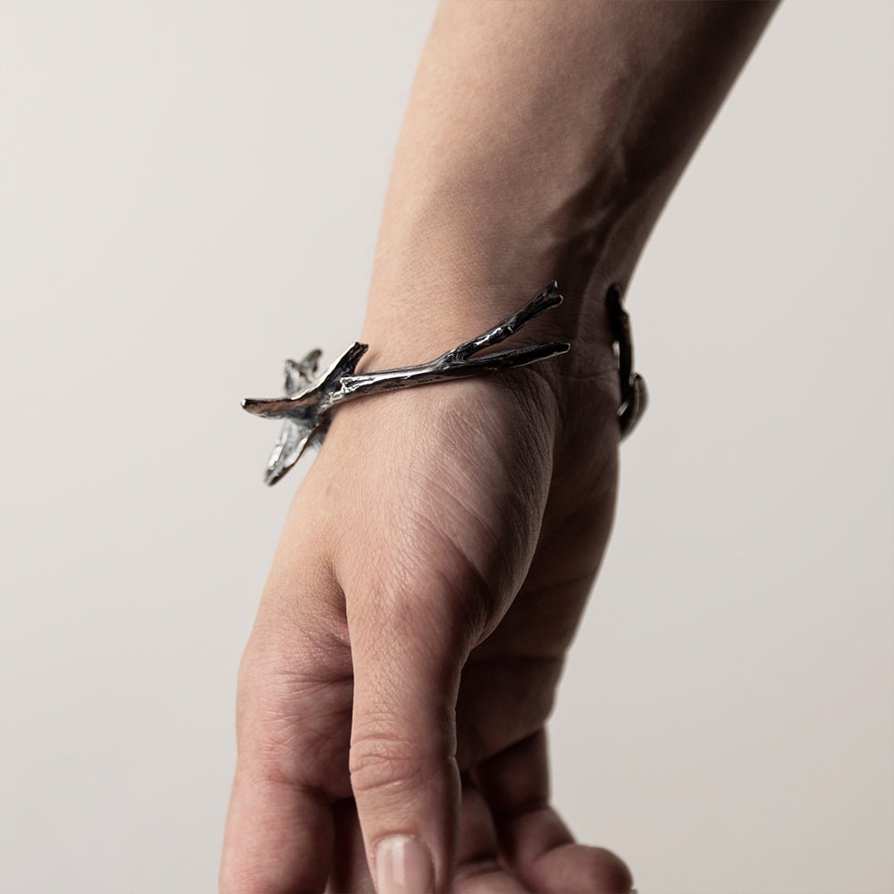 Vertebrae Crest Bracelet on a wrist, shows the back of the hand with opening of the cuff visible