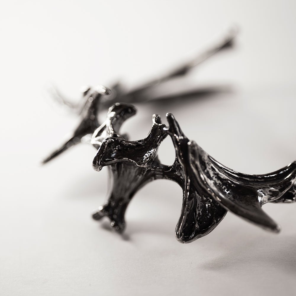 Vertebrae Crest Bracelet placed on a white surface - close up of the decorative elements and texture