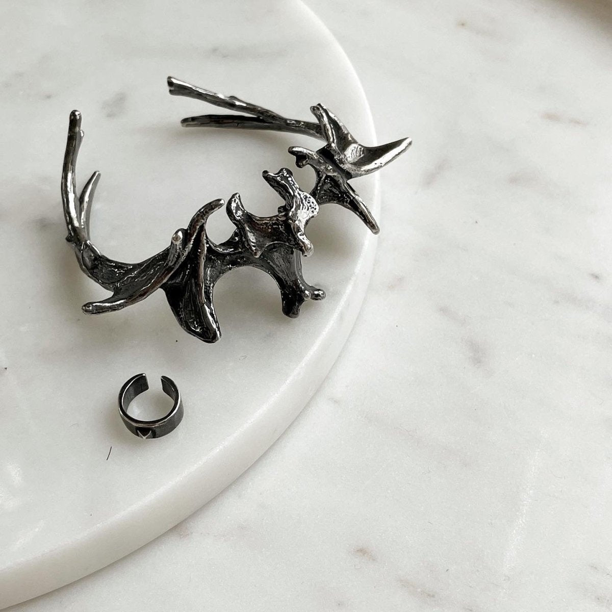 Vertebrae Crest Bracelet placed on a white marble surface