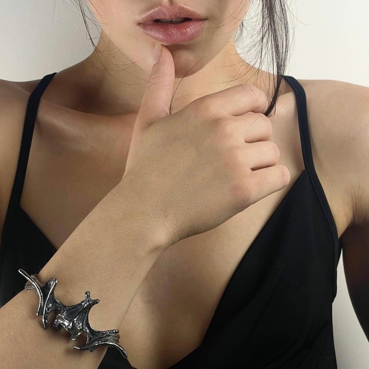 Vertebrae Crest Bracelet on a female model in a strap black dress
