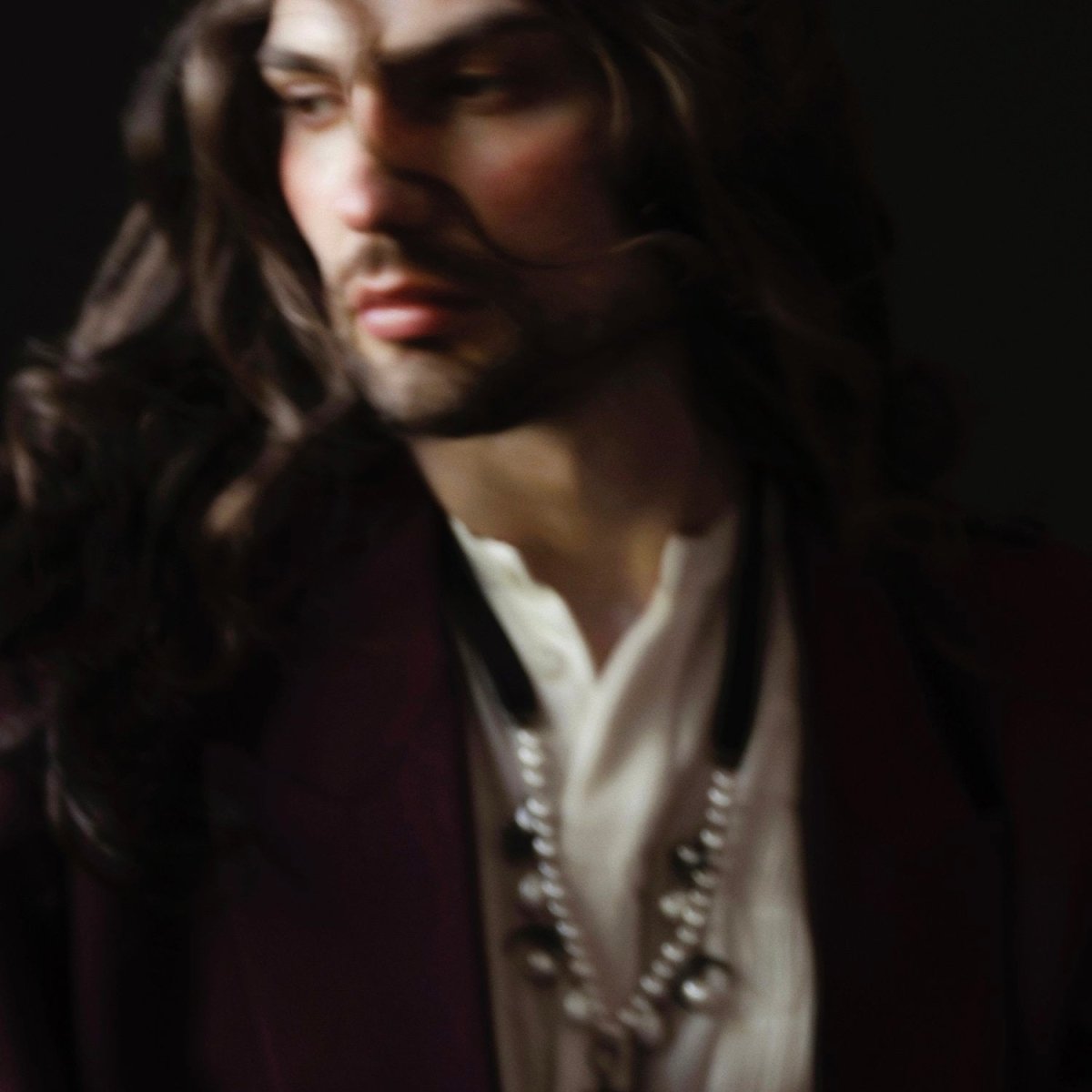 Stars and Moons choker on a male bearded model with long curly hair, fashion editorial