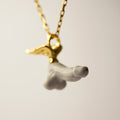 Fascinus pendant - gold variant - focus on marble charm, gold-plated silver fixture slightly blurry